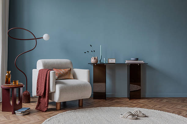 istock Modern blue interior with cream armchair, sculptural lamp, and minimalist console table decor. 2213851042