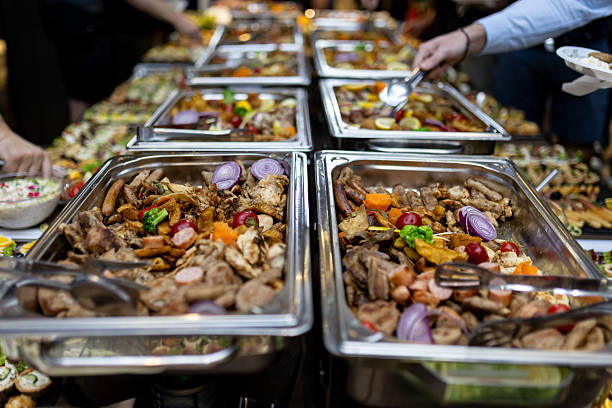 istock Buffet spread featuring various grilled meats, vegetables, and side dishes at a festive gathering 2213851150
