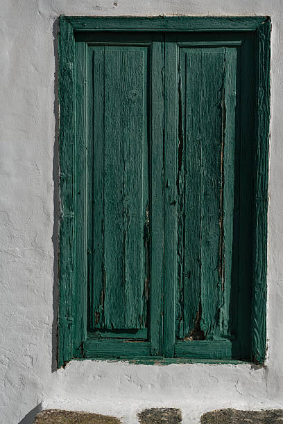 istock old green wooden window with shutters 2213851786