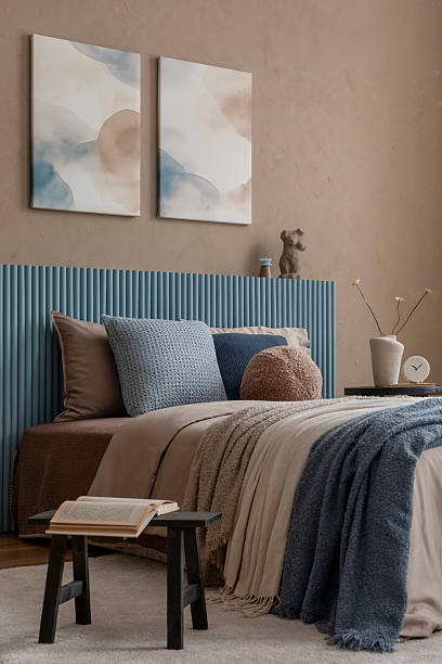 istock A refined bedroom setting with a muted palette, featuring elegant abstract artwork, a sculptural bedside table, and textured textiles for a sophisticated and calming space. 2213851984