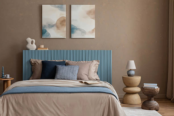 istock A tranquil bedroom setup with a blue accent headboard, layered blankets, and organic shapes, evoking a sense of calm and comfort. 2213852020