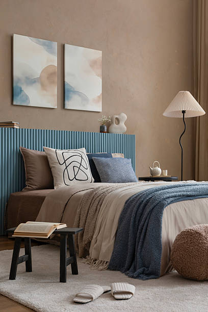 istock A modern bedroom with a ribbed headboard, a mix of soft neutrals and deep blue textiles, and minimal decor for a relaxing ambiance. 2213852032