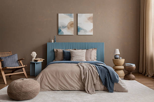 istock Warm and inviting bedroom featuring a natural wood side table, sculptural decor, and abstract paintings above the bed. 2213852048