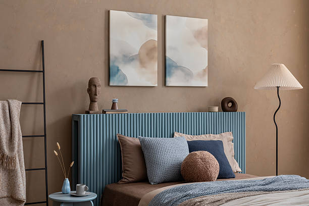 istock Stylish bedroom with a soft beige and blue palette, featuring a textured bedspread and sculptural decor elements. 2213852064