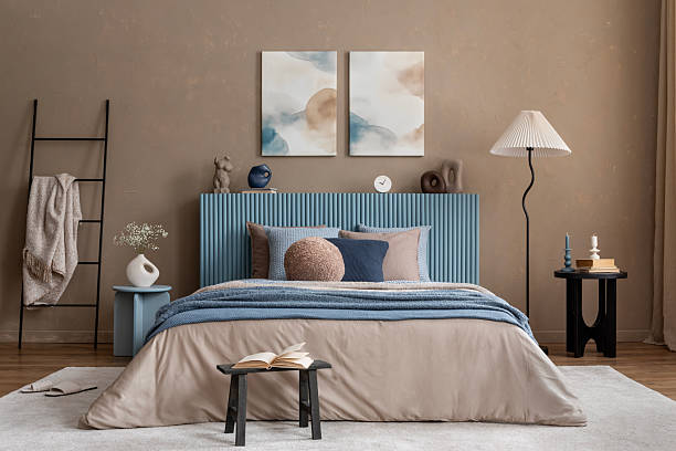 istock Minimalist bedroom decor with abstract artwork, a soft-toned bed, and sculptural bedside accessories in organic shapes. 2213852068