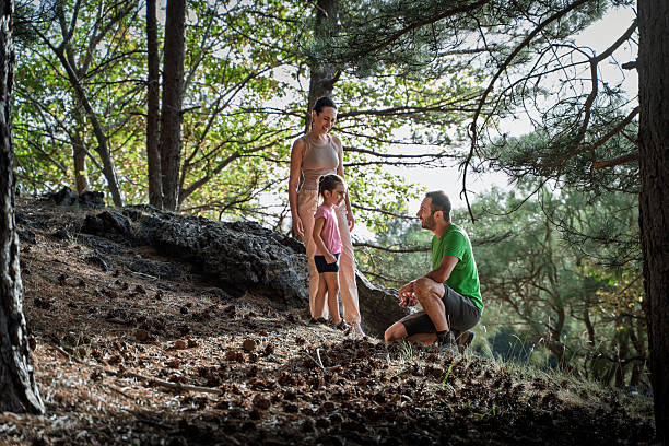 Happy family moments as they enjoy a nature walk along a cobblestone path. A peaceful atmosphere showcasing connection, relaxation, and the beauty of the natural environment.