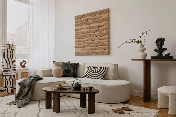 istock Elegant lounge space with curved sofa, abstract artwork, and a curated console arrangement in earthy hues. 2213855163