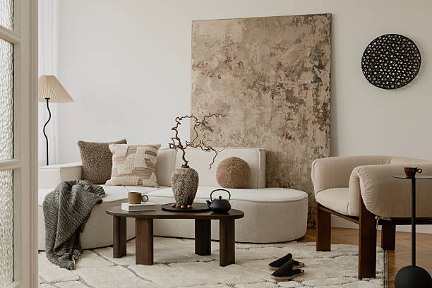 istock Bright neutral living space with textured pillows, soft boucle seating, and a ceramic vase as the focal point. 2213855169