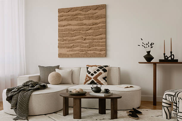 istock Contemporary neutral-toned living space with bold textiles, ceramic tea set, and geometric wall art. 2213855180