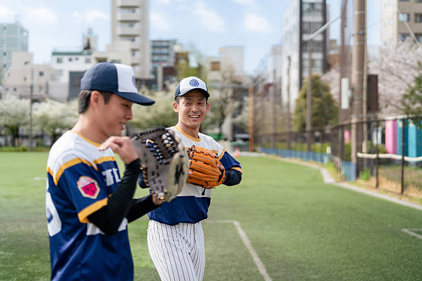 istock Smiling Baseball Players Practicing on a Sunny Community Field in Tokyo 2213855903