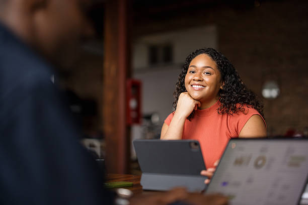 istock Happy black businesswoman day dreaming while using touchpad in the office. 2213856868
