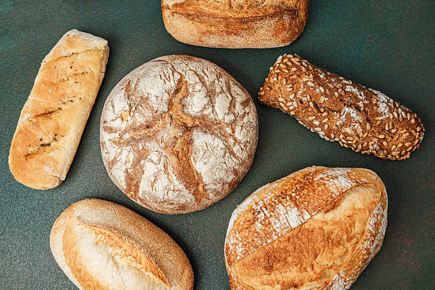 istock Freshly baked artisan bread varieties arranged on a dark surface 2213857003
