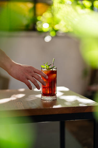 istock A man picks up an iced coffee with his hand. 2213859010