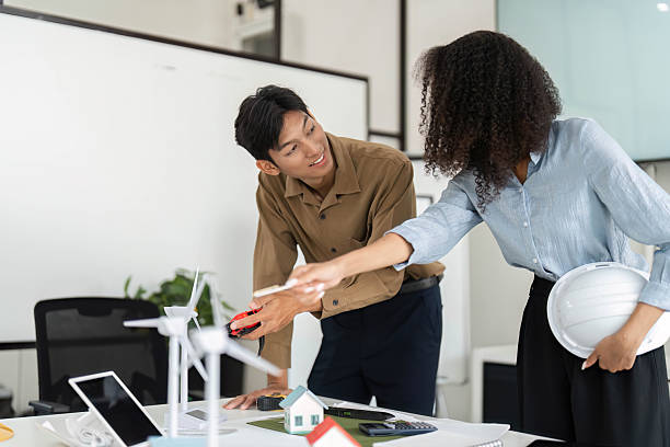 istock Collaboration and Innovation in Sustainability. Professionals discussing eco-friendly housing solutions. 2213859310