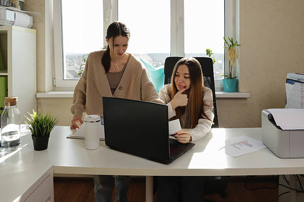 istock Collaborative office environment with printed reports, digital tools, and two engaged coworkers reviewing data, representing everyday teamwork in a small business or freelance studio. 2213859386