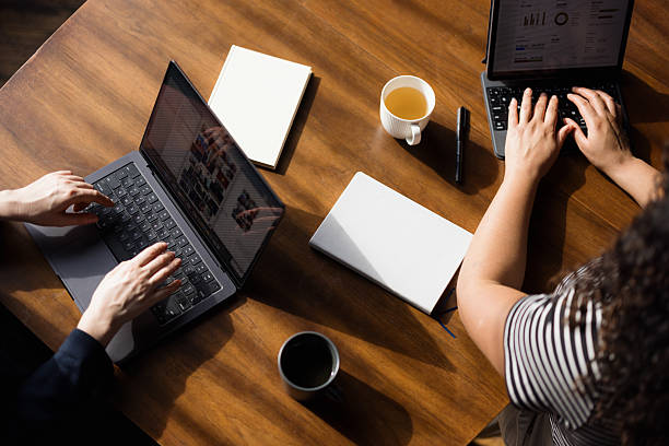 istock Above view of working on computers in the office. 2213861897
