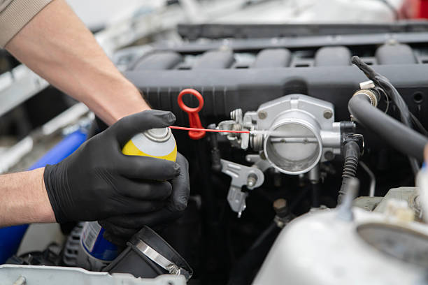 istock Spraying Throttle Valve Cleaner in a Car Engine for Effective Maintenance and Improved Performance 2213864252