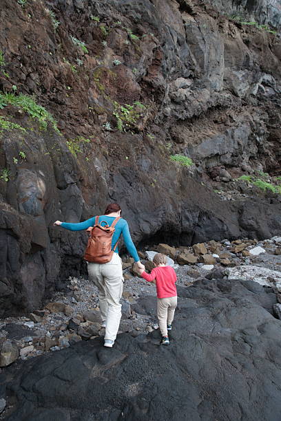 istock Mother and son exploring volcanic caves holding hands 2213871297