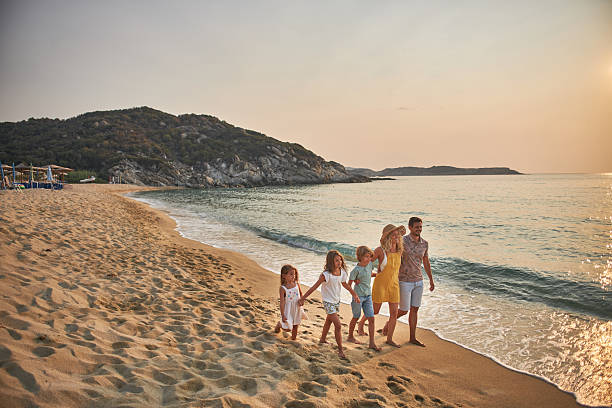 istock A family walks hand in hand down a tropical paradise beach during sunset 2213872182