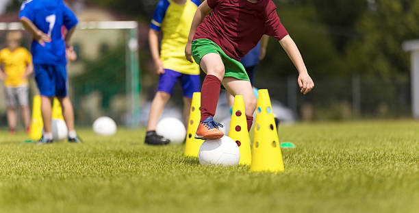 istock Children Practicing Soccer Drills on Field with Cones During Youth Training Camp 2213872189