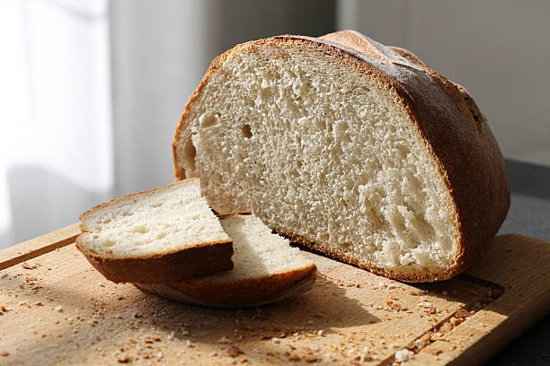 istock Traditional bread at the table in the morning sun rays 2213872631