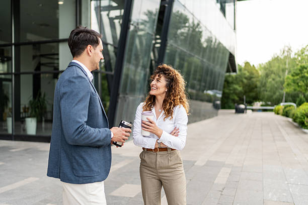 istock Business partners having a coffee break chatting outside the office 2213873185
