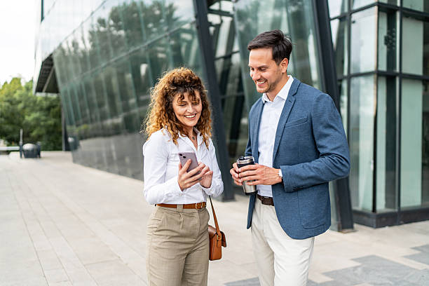 istock Businesspeople walking and talking outside office building 2213873815
