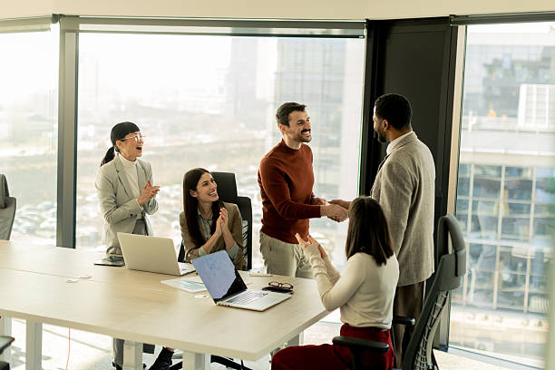 istock Team collaborates in modern office setting on innovative project with laptops and discussion 2213873828