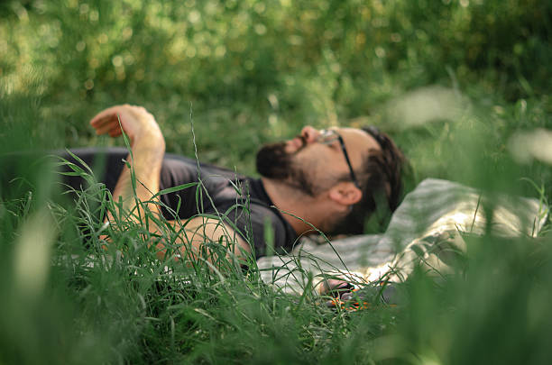 istock Young Man Relaxing on Grass Mat During Spring Break from Work- Peaceful Spring Day Rest – Man Lying on Grass Mat Outdoors 2213875753