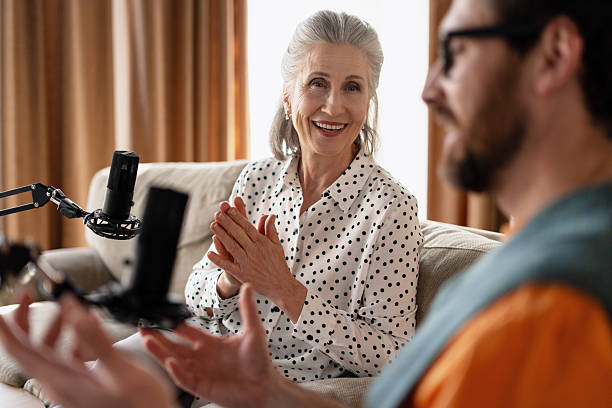 istock Elderly woman being interviewed for a podcast in a home studio 2213876416