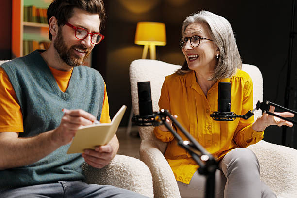 istock Podcasters recording audio content in home studio 2213876475