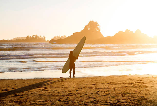 istock Mature female surfer at sunset 2213881128