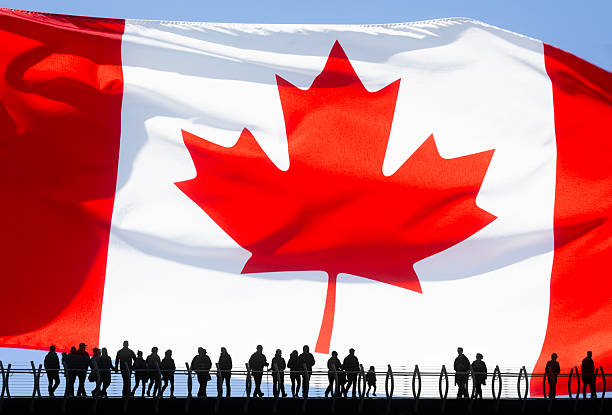 Human face painted Canada flag with the red maple leaf on the center of eye or eyeball. Human eye painted with flag of Canada.