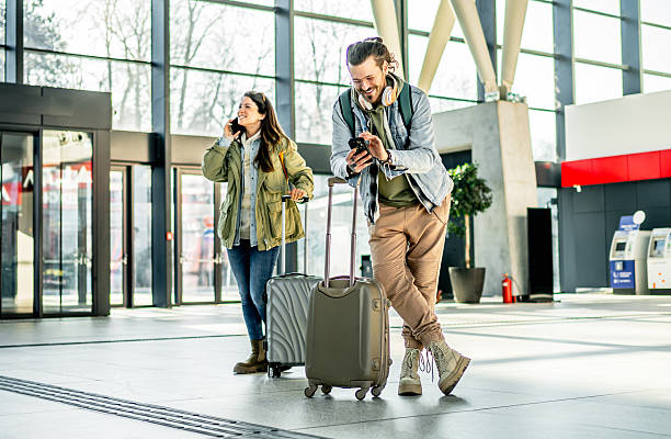 istock Tourists using smartphones while waiting at the airport 2213881717