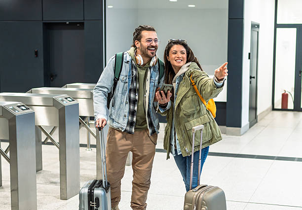 istock Tourists finding their way in the train station 2213881788