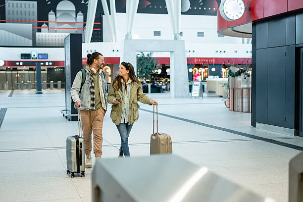 istock Tourists walking with suitcases in the train station 2213882036