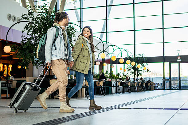 istock Tourists holding hands walking in the train station 2213882226