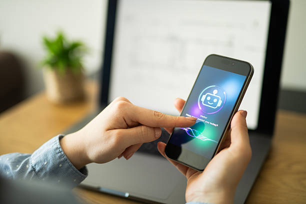 istock Woman in business uses AI chatbot on mobile while working on computer. 2213882554