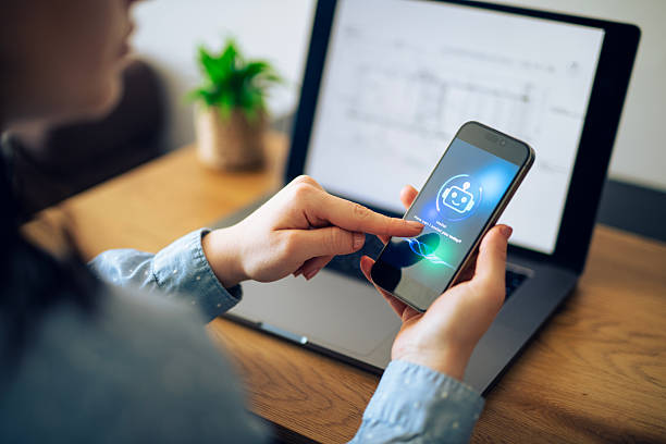 istock Woman in business uses AI chatbot on mobile while working on computer. 2213882574