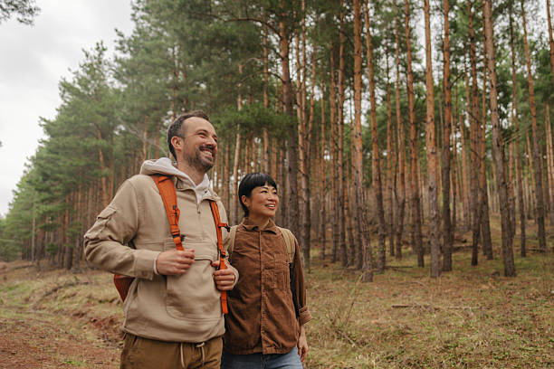 istock Happy couple exploring the woods together 2213885705