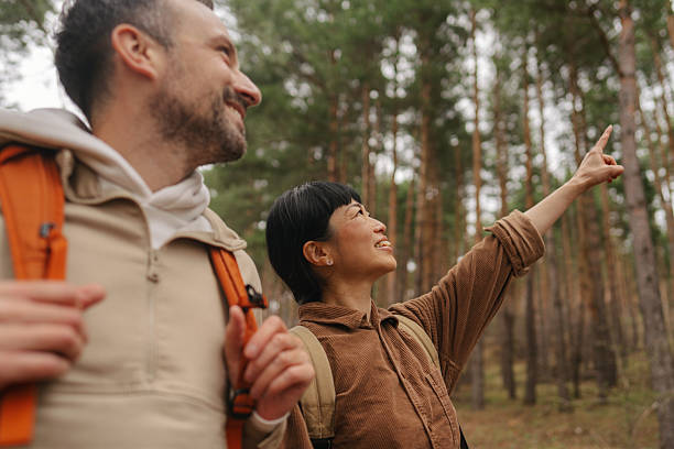 istock Happy couple exploring the woods together 2213886279
