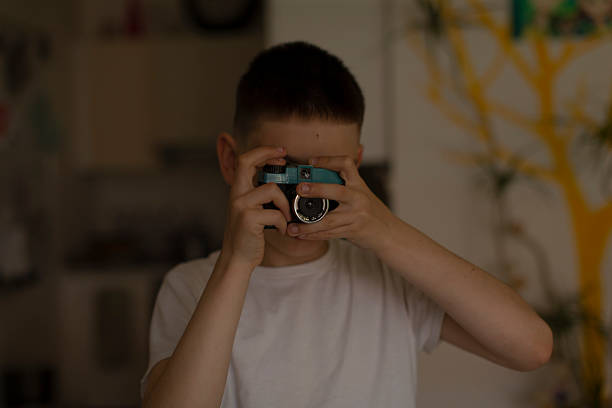 istock A child happily using a camera to capture moments in a bright room 2213887440