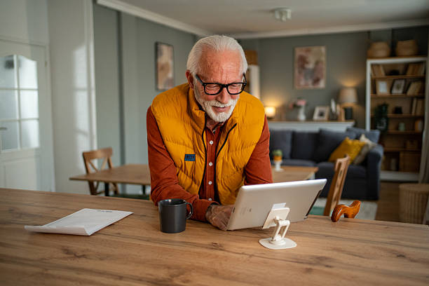 istock Senior man using digital tablet at home for video call 2213888406