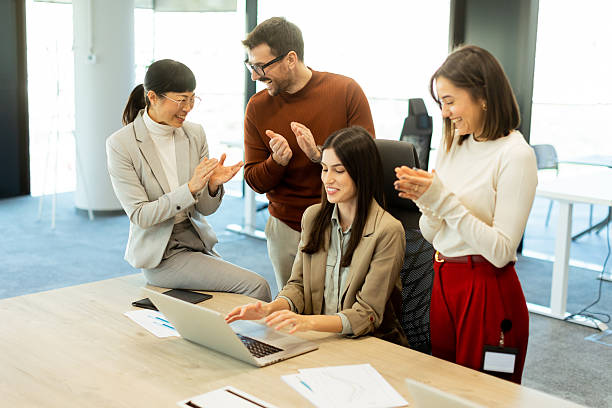 istock Team celebrates success together in a bright modern office environment 2213889373