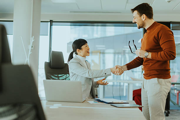 istock Successful business meeting between two professionals in a modern office setting 2213889388