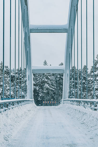 istock Winter landscape featuring a snow-covered bridge in Sweden surrounded by forest 2213892215