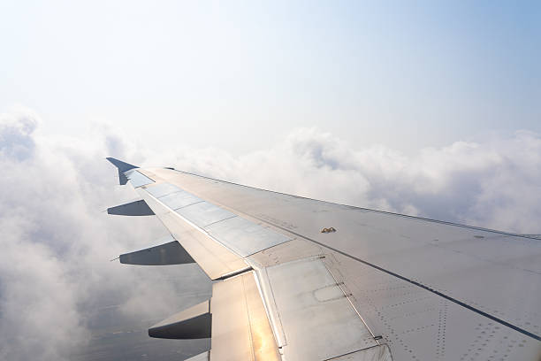 istock Journey above the clouds with a sleek airplane wing cutting through the bright sunlight at high altitude 2213894556