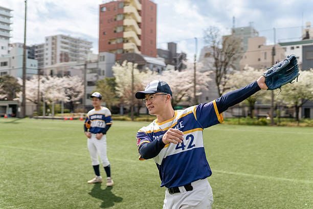 istock Local Baseball Team Practicing on a Sunny Day with Cherry Blossoms 2213895284