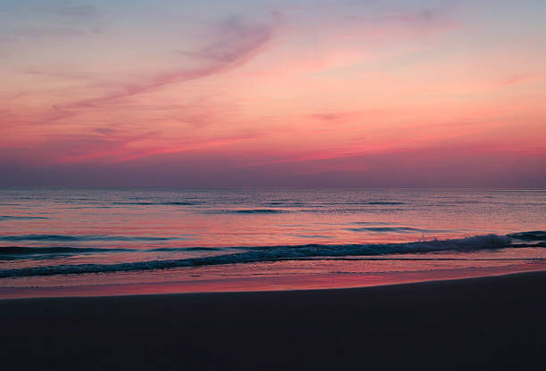 istock Cornish coastline at sunset with gentle waves and rocks, pink sky and cliffs in silhouette, Cornwall, England,  United Kingdom, UK 2213895384