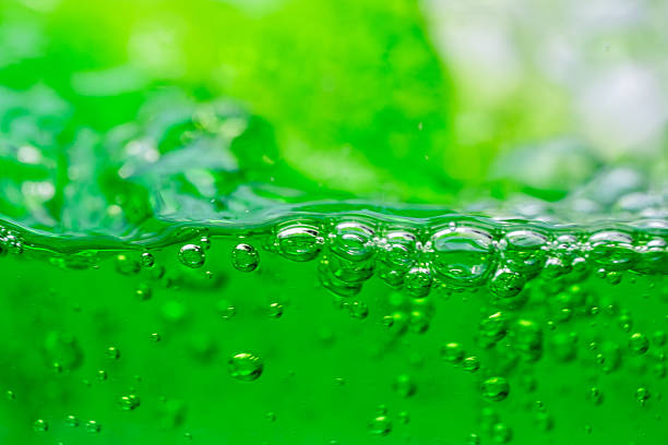 istock Water wave, close up of vibrant green liquid with bubbles, capturing dynamic movement and freshness. Perfect for backgrounds, beverages, or abstract concepts. soft drink 2213895725